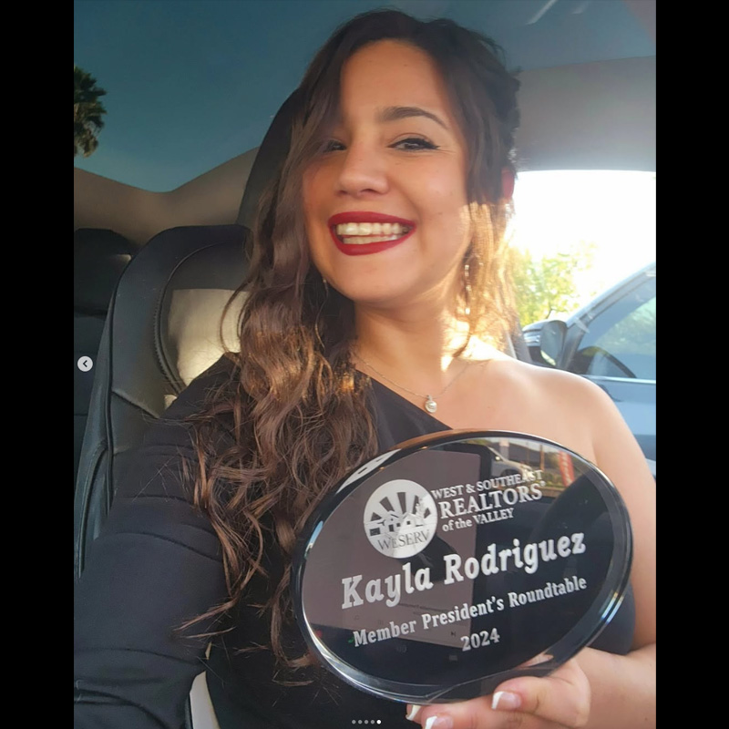Kayla Rodriguez, Realtor, holding her 2024 WeSERV President’s Roundtable member award.
